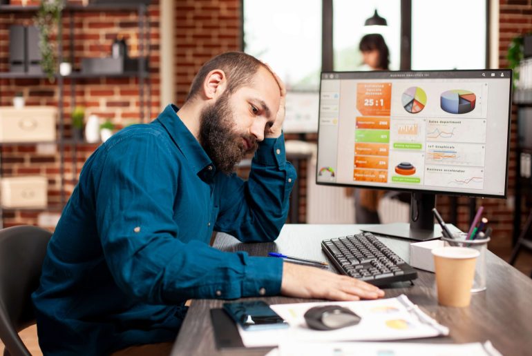 exhausted-businessman-holds-his-forehead_11zon