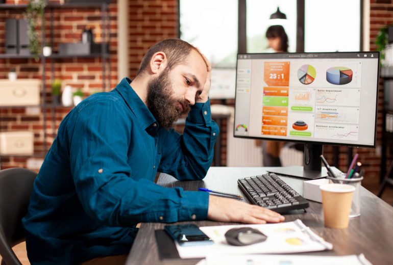exhausted-businessman-holds-his-forehead_11zon